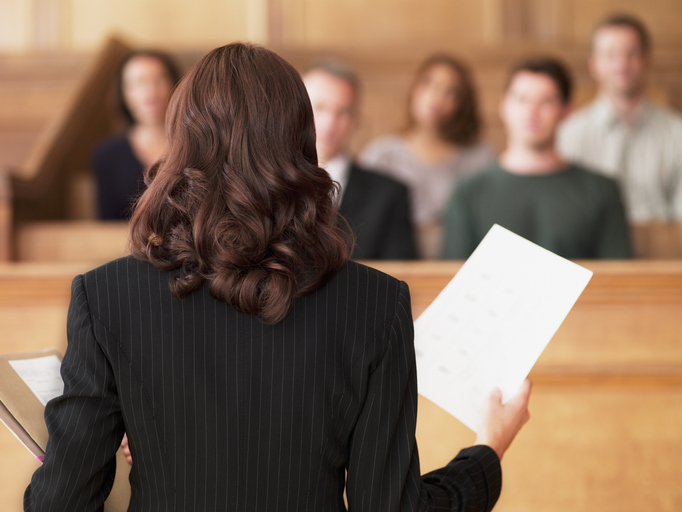 A barrister stands before a court of law giving evidence to a court of law