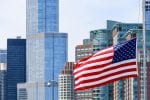 New York City skyline with a billowing United States of America flag